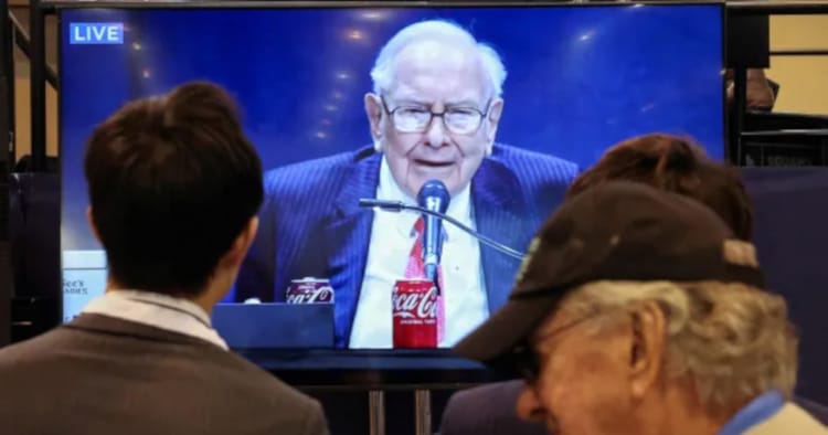 Attendees watch a live broadcast of Berkshire Hathaway shareholder meeting